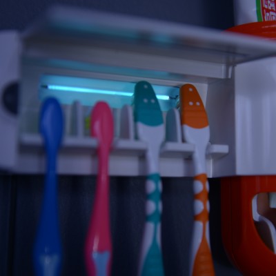 UV toothbrush sterilizer and toothpaste dispenser ,high sanitizing rate 99.9%,toothpaste squeezer machine manufacturer